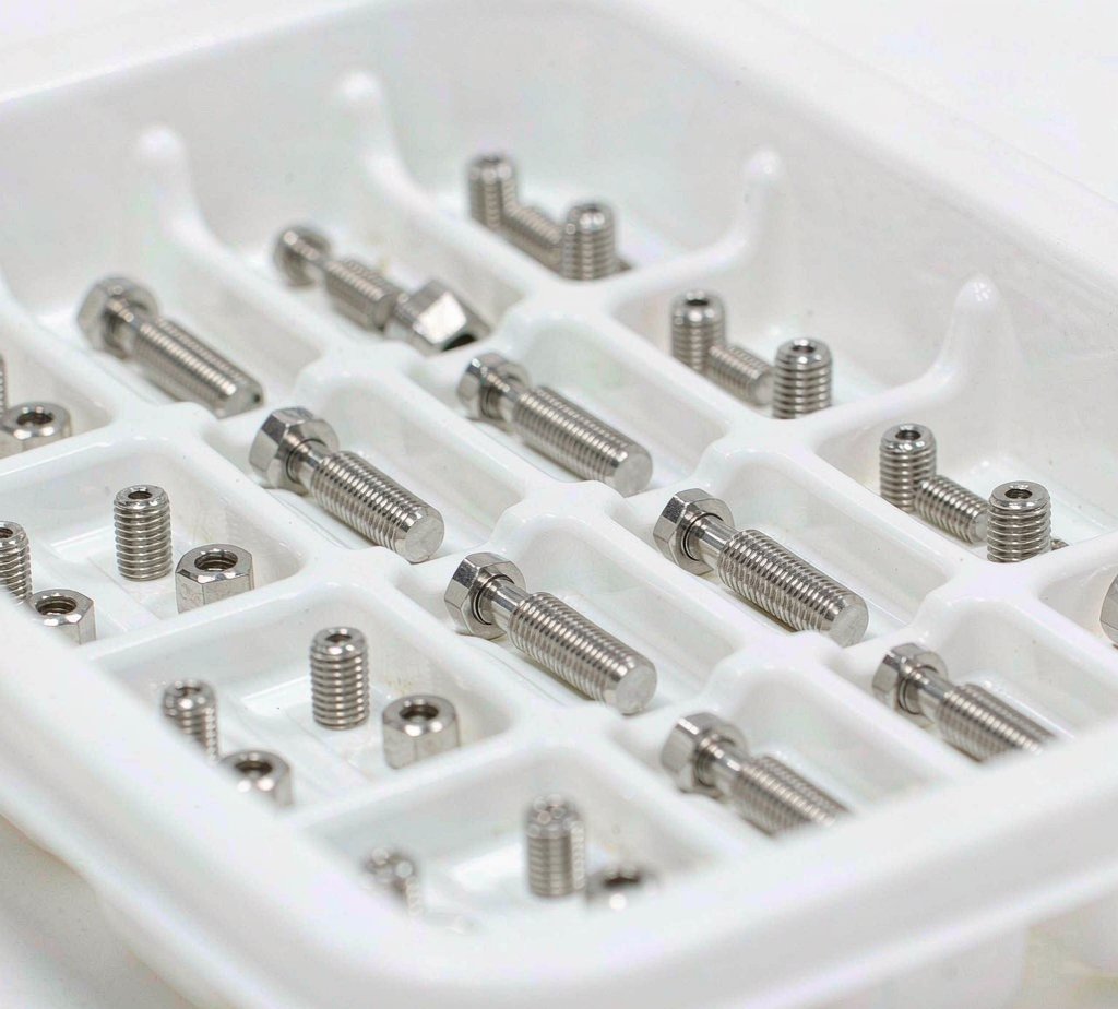 Precision stainless steel medical instrument components in tray