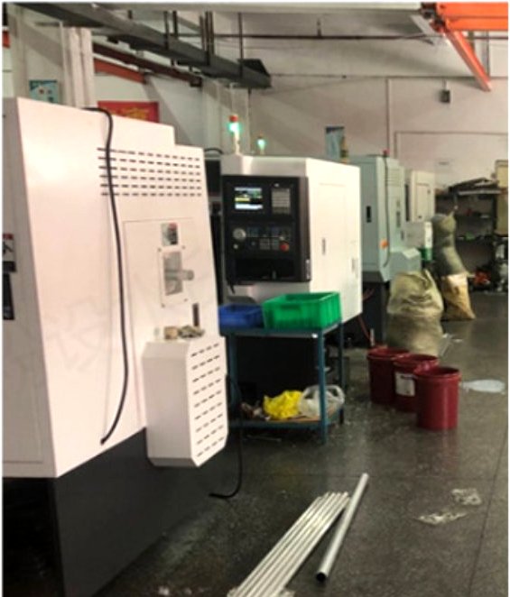 Machining bay with overhead crane and CNC machines at our Shenzhen facility