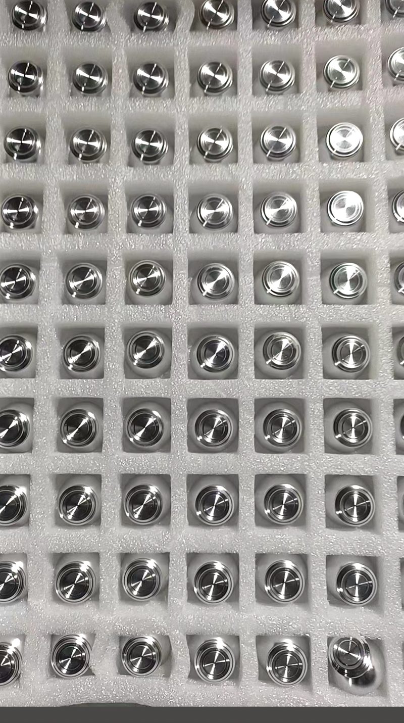Stainless steel machined parts nested in a protective foam tray before packing