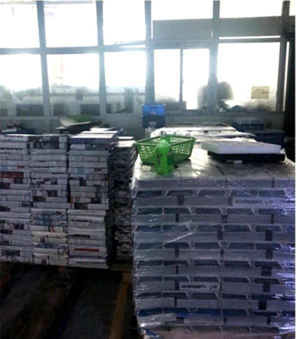 Team member packing finished parts into export cartons