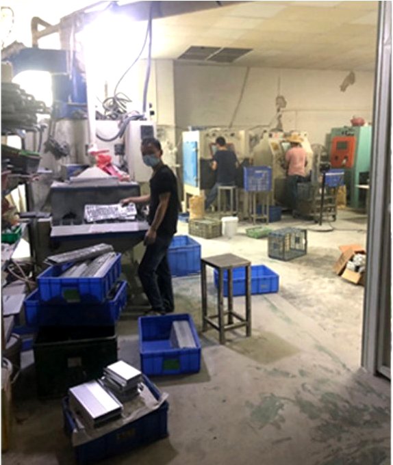Team member organizing freshly machined aluminum parts at a milling station in our Shenzhen workshop