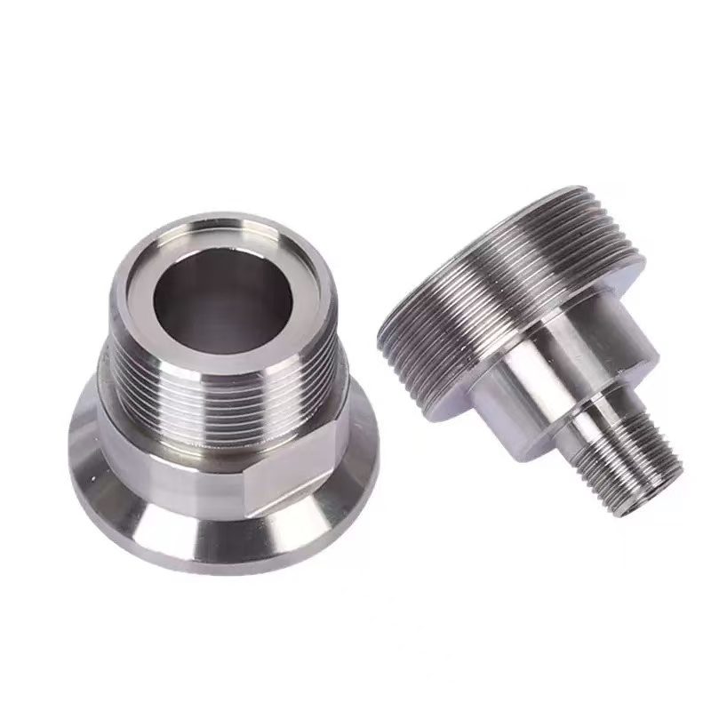 Precision machined steel and stainless parts laid out on an inspection workbench before QC