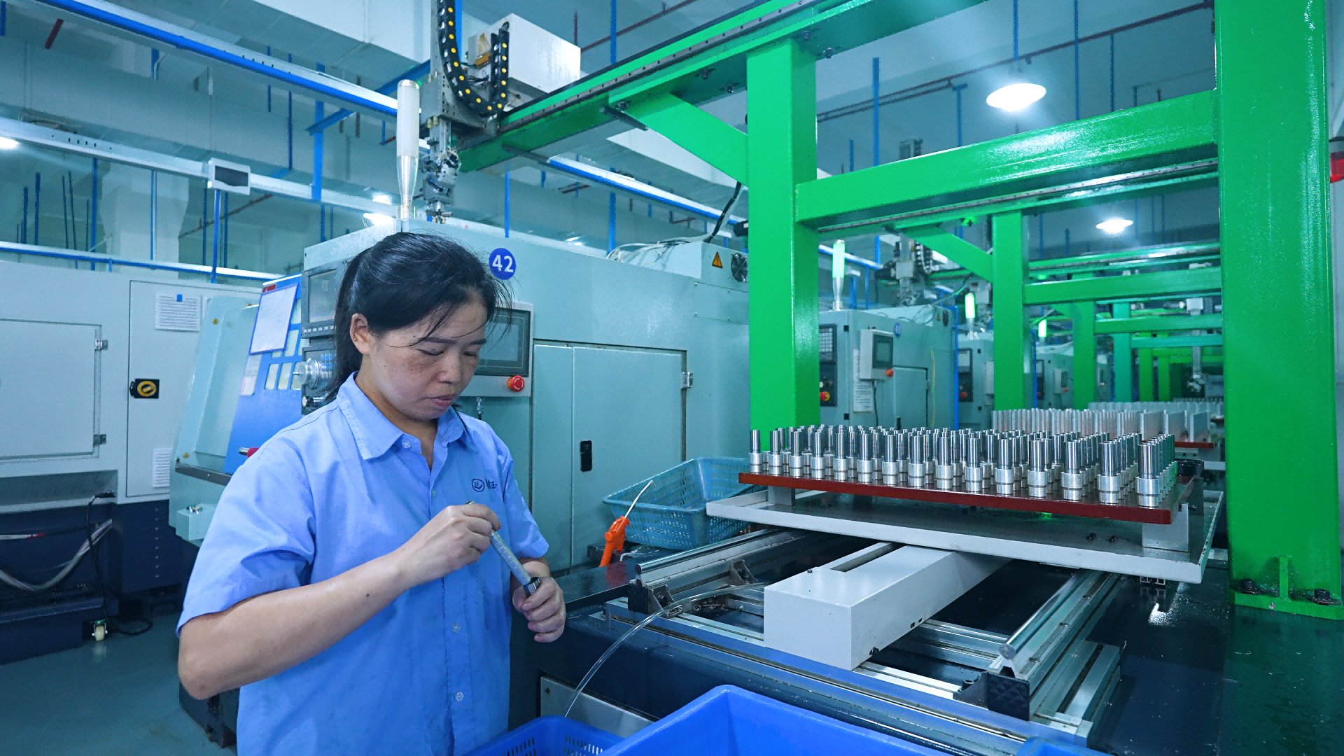 Machinist inspecting finished CNC machined parts before packaging