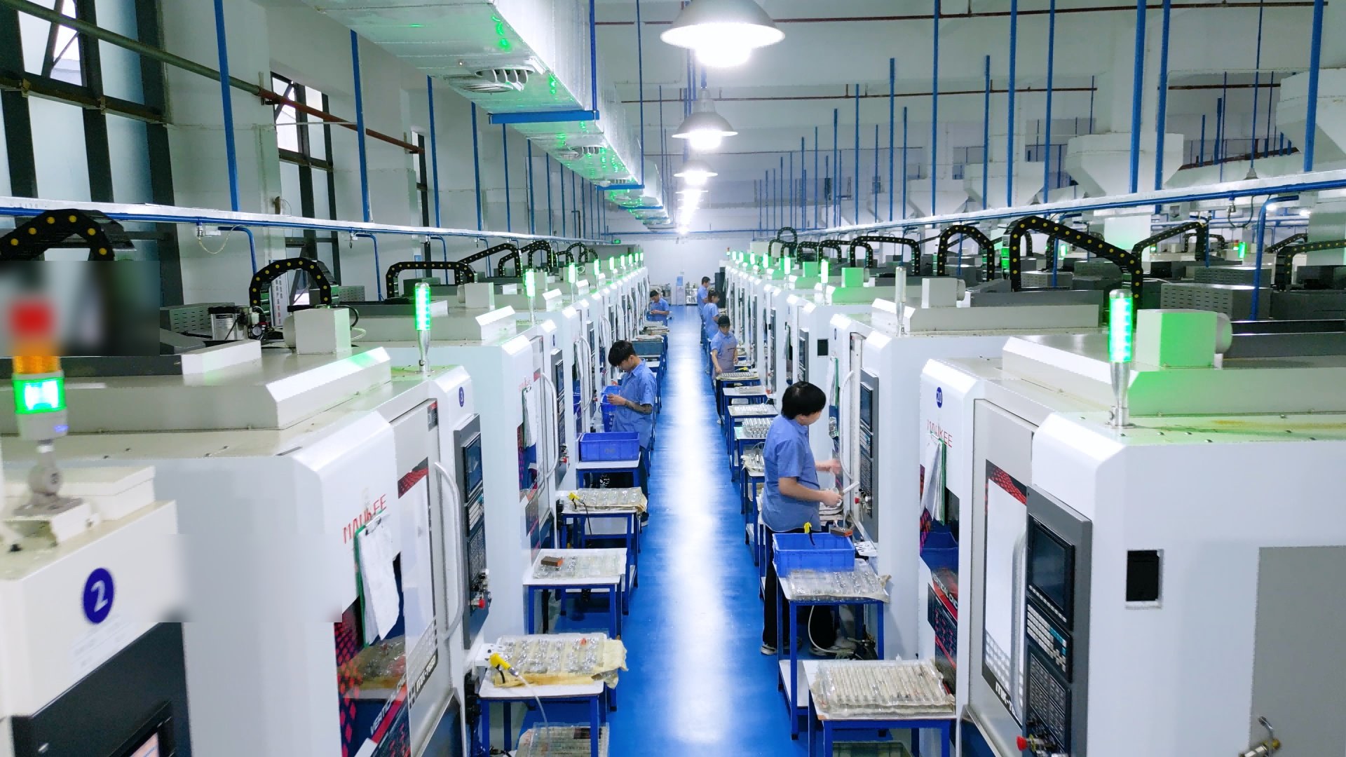 CNC machining workshop overview showing rows of CNC machines in production